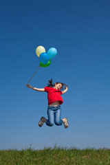 Girl holding balloons, jumping outdoor