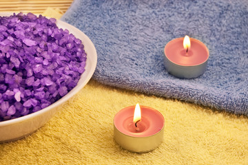 Fototapeta na wymiar Violet bath salt and two candles