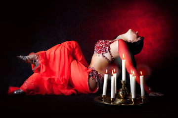 Belly dancer with burning candles