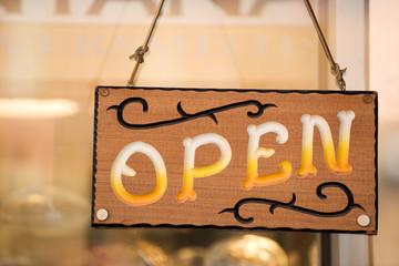 Open sign on the door of country western shop