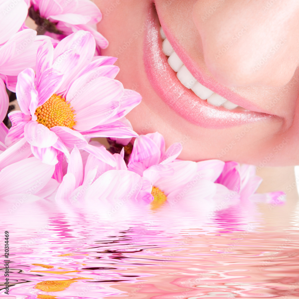 Wall mural Smile of young woman with flowers