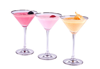 Three bright multi-coloured cocktails with the berries