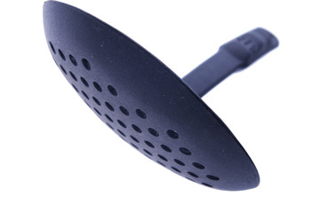 plastic kitchen skimmer spoon isolated on white