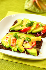 toast with avocado and tomato with cheese