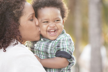 Mother kissing her smiling child