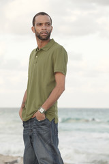 Handsome African American man posing on the beach