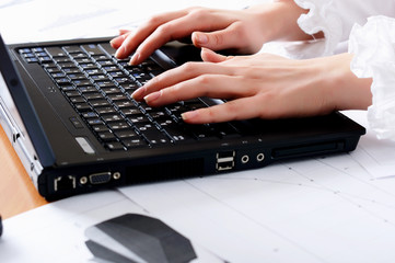 hands of a young girl working on laptop