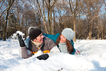 Fototapeta na wymiar Couple playing in snow