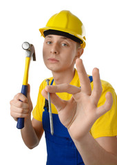 Young serene worker with hammer and nail