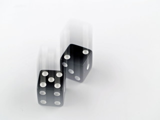 Black and white dice falling on a white background