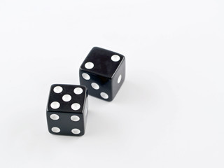 Black and white dice falling on a white background