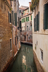 Fototapeta na wymiar Small Side Canal Reflection Venice Italy