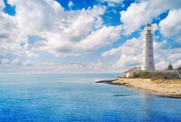 Poster Old lighthouse on sea coast © Alexander Ozerov