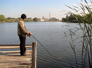 Fototapeta premium The fisherman on the bridge