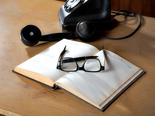 The old daily log with glasses and phone