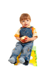 boy with apple sitting on chair