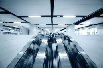 People using escalator, blurred motion