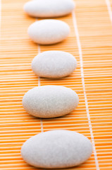 Fototapeta na wymiar Stack of spa pebbles against blurred background