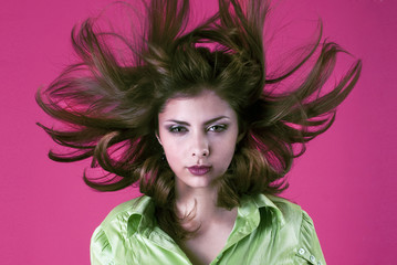 Naklejka premium studio portrait of a sweet girl with flying hair