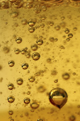 Fototapeta na wymiar Fiolek powietrza w złotym płynem. Background