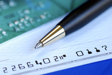 Write a check to pay the credit card bill isolated on blue