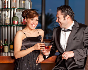 Young couple at bar drinking and flirting
