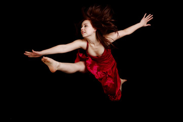 Naklejka premium Woman in red dress jumping