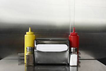 Napkin dispenser and condiments.