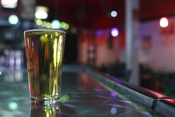 pint of beer on the counter at a bar