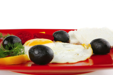 fried egg served on red dish