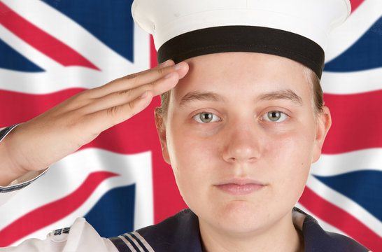 young sailor saluting in front of union jack