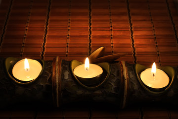 Candles on bamboo rug