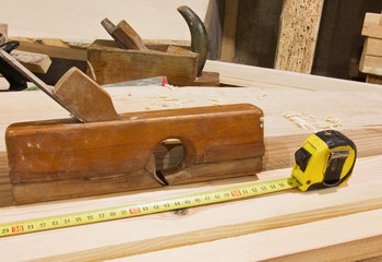 Desktop with tape-measure and old smoothing plane