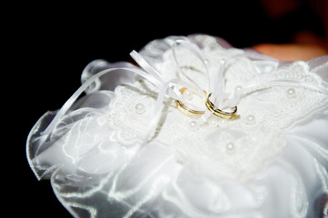 Wedding rings on a satin pillow
