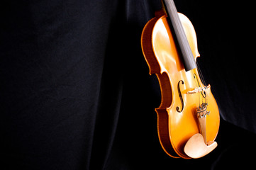 violin body leaning on black
