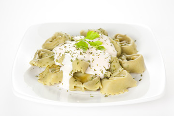 dish of tortellini with cheese sauce
