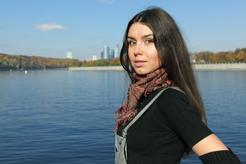 The beautiful girl stand on river bank Moscow