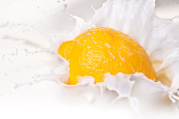 splash of lemon falling in cream