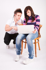 Teen boy and girl with laptop