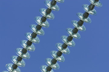 High-voltage electrical insulators against the blue sky