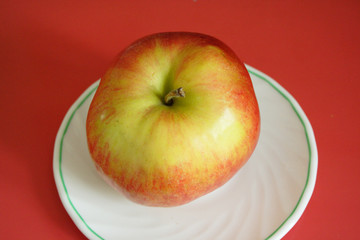 An apple on a white plate