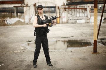 young and attractive woman holding an assault rifle