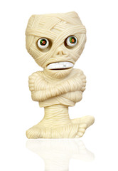 Fototapeta na wymiar Beige plastic toy as a mummy