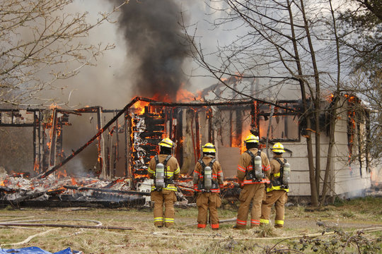 Firemen at burning house.