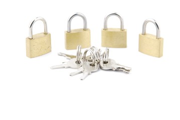 Golden closed padlocks with keys on white