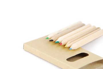 Colour pencils and pencil case on white
