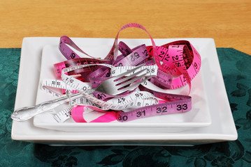 tape measures on a plate with fork