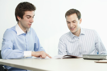 Obraz premium Handsome Young Businessmen Smiling and Reading