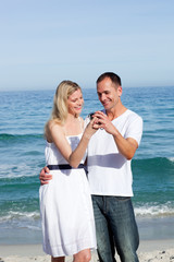 Happy couple looking at holiday photograph