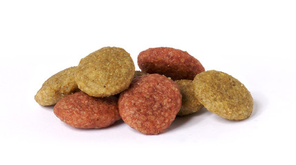 small pile of dog food kibble isolated on white background